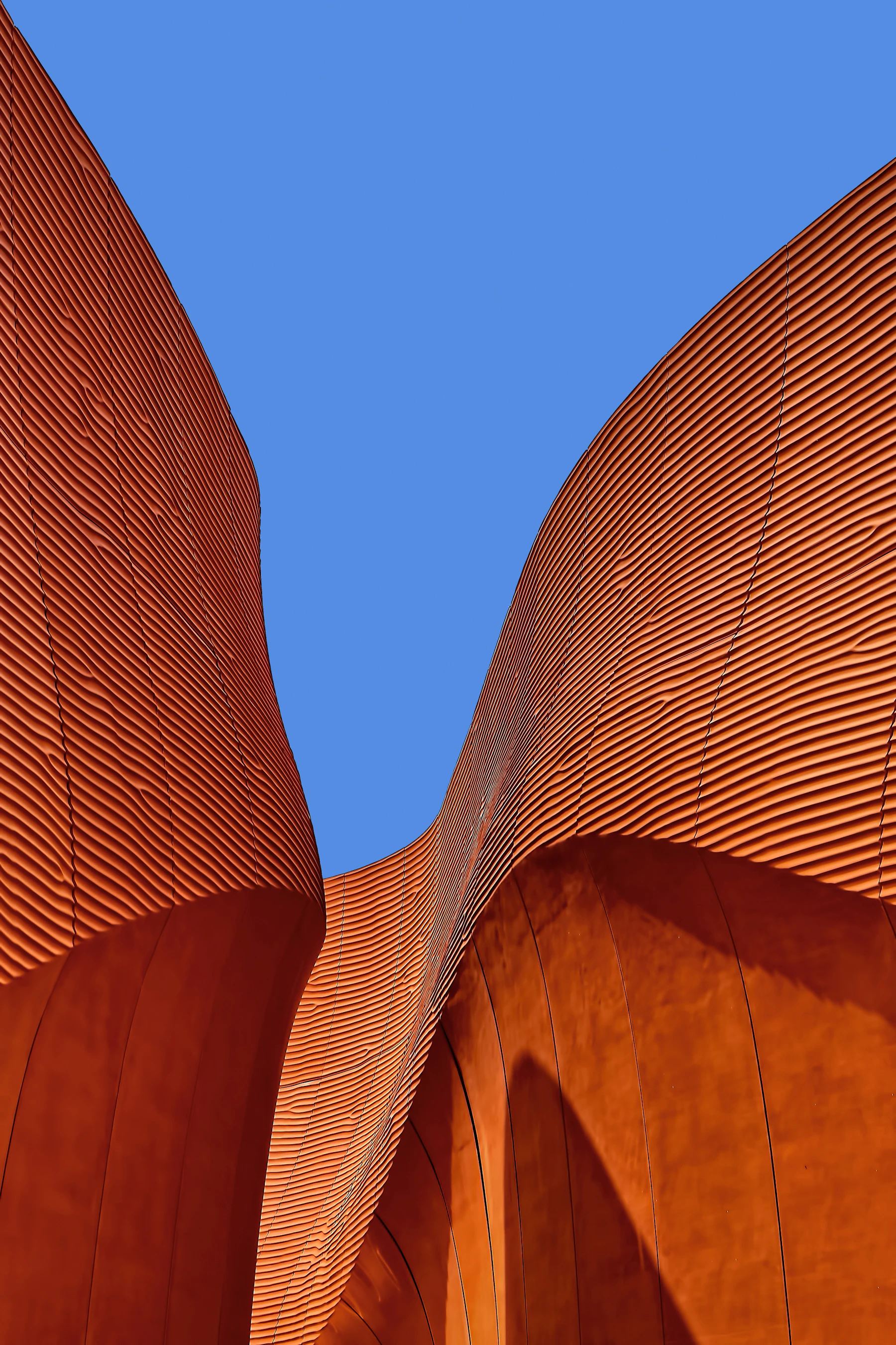 Placeholder photograph of a sweeping ochre facade against blue sky