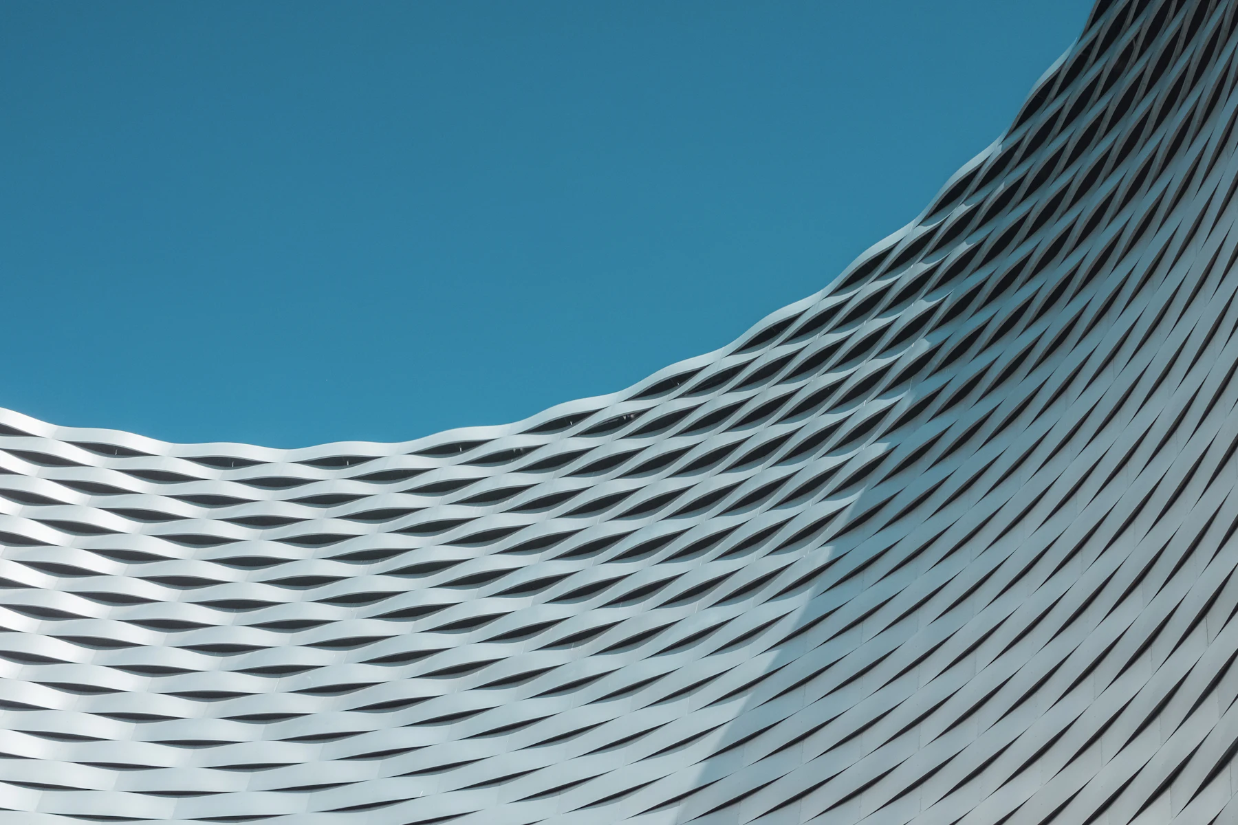 Placeholder photograph of an undulating perforated facade